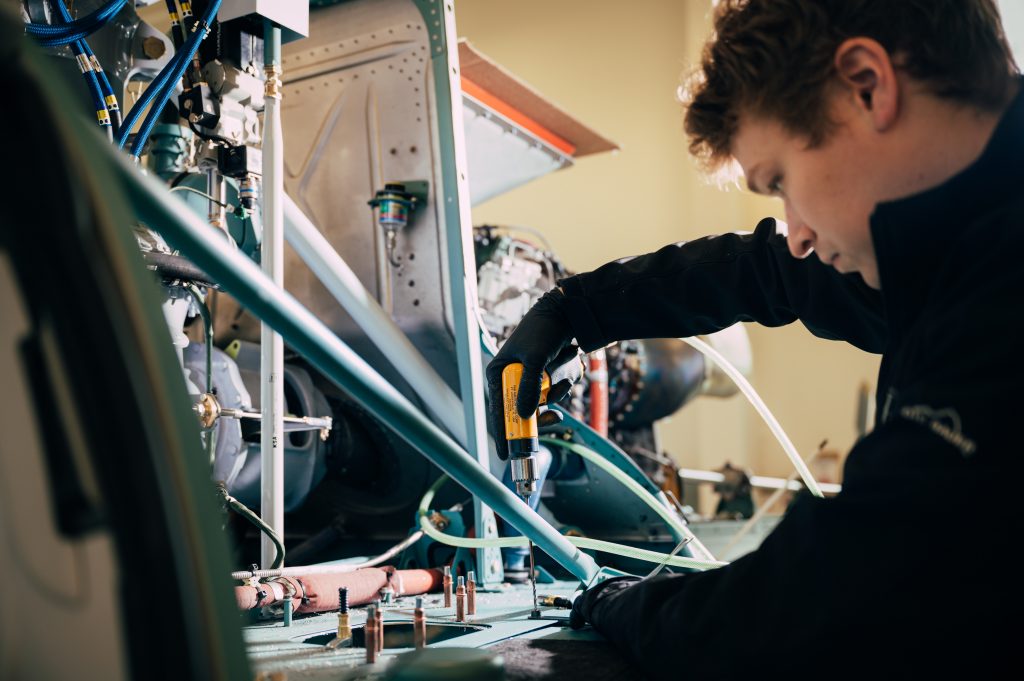 A mechanic performing helicopter maintenance